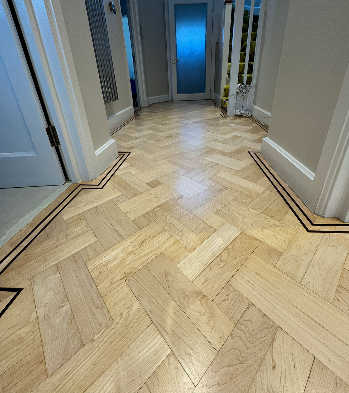 basket-weave-flooring-refurbishment an image of refinished board samples being compared by homeowners