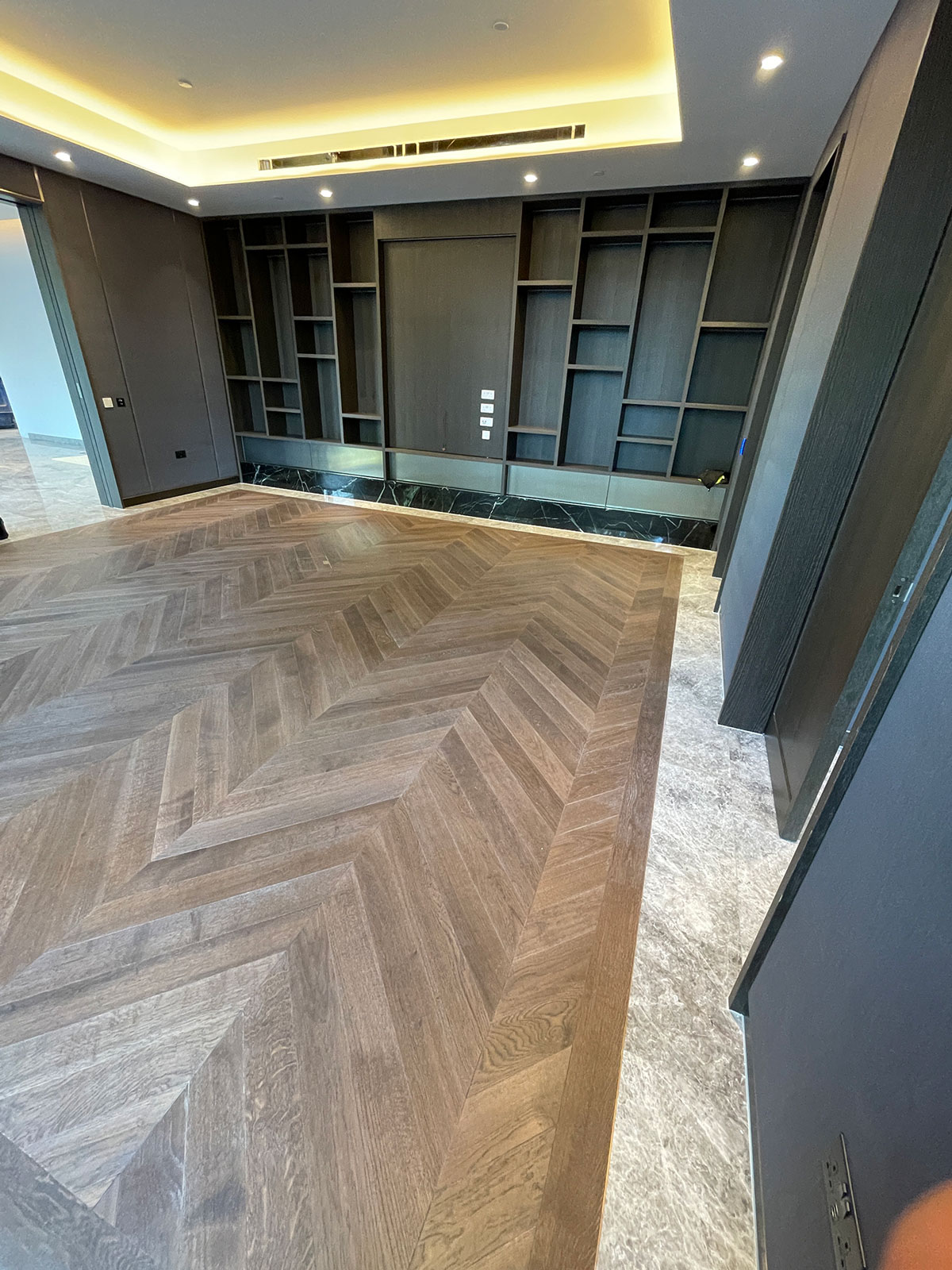 chevron-wood-flooring-new-build Image of concrete sub floors being laid near to a door frame
