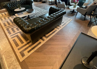 Luxury living area with chevron style oak flooring